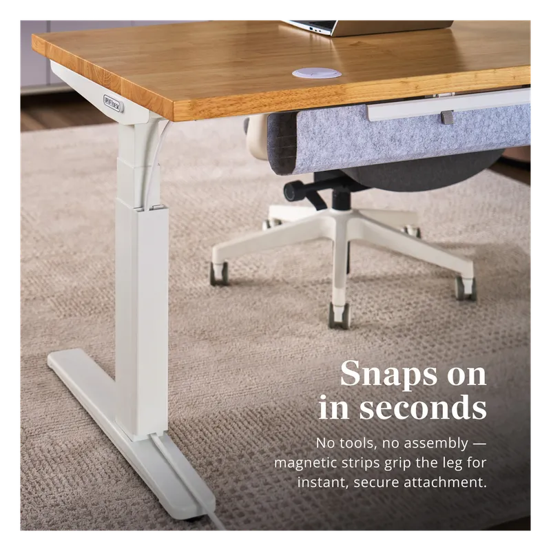 UPLIFT magnetic cable channel snapped onto a white standing desk leg
