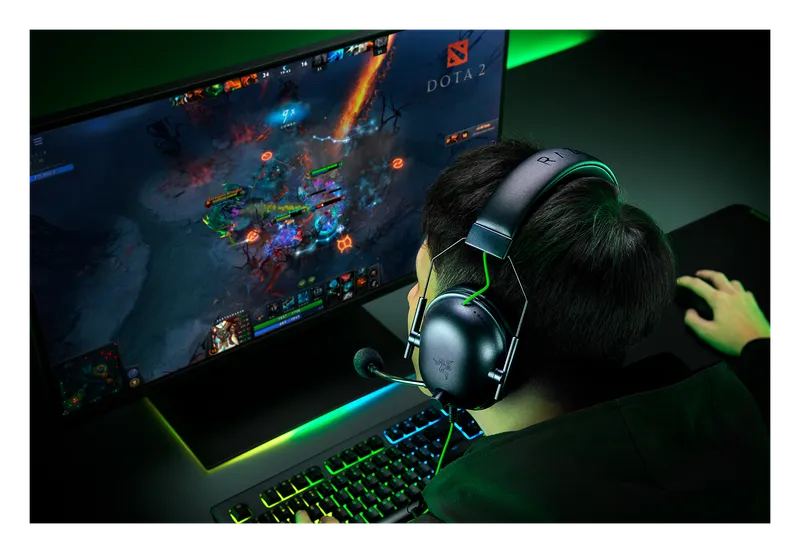 Gamer wearing the Razer BlackShark V2 X headset at a PC