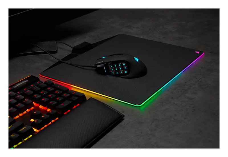 Corsair Scimitar RGB Elite mouse on an RGB mousepad next to a keyboard
