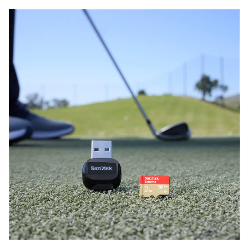 SanDisk Extreme microSD card and card reader on a golf course