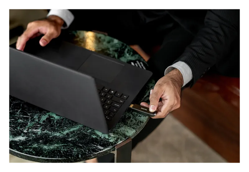 SanDisk Extreme PRO flash drive being plugged into a laptop