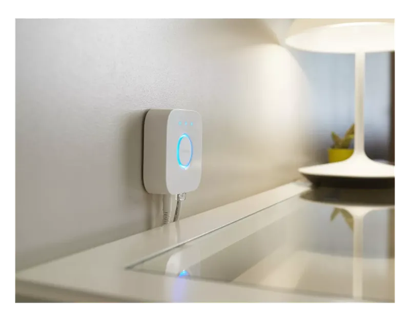 Philips Hue Bridge on a shelf at home