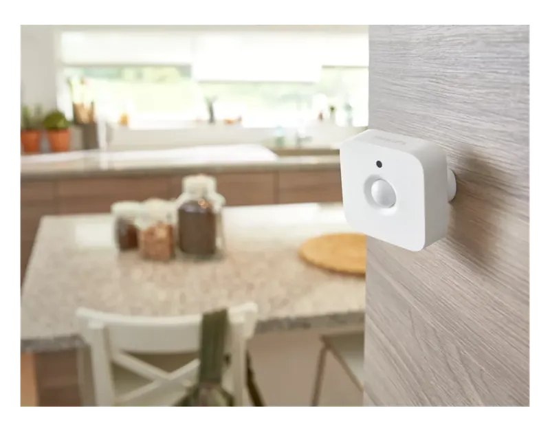 Philips Hue Motion Sensor mounted on a kitchen wall