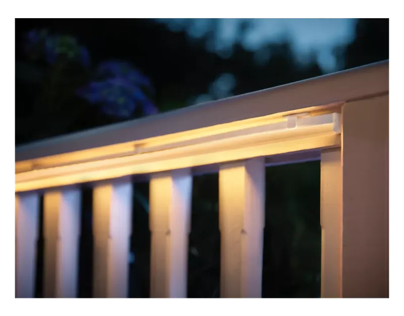 Philips Hue Outdoor Lightstrip lighting a deck railing