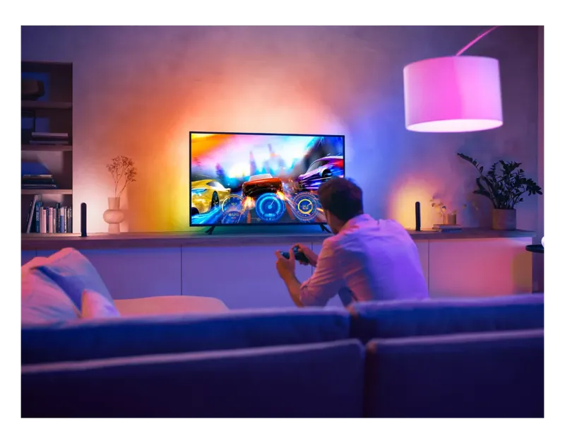 Philips Hue Play Gradient Lightstrip glowing behind a TV during gaming