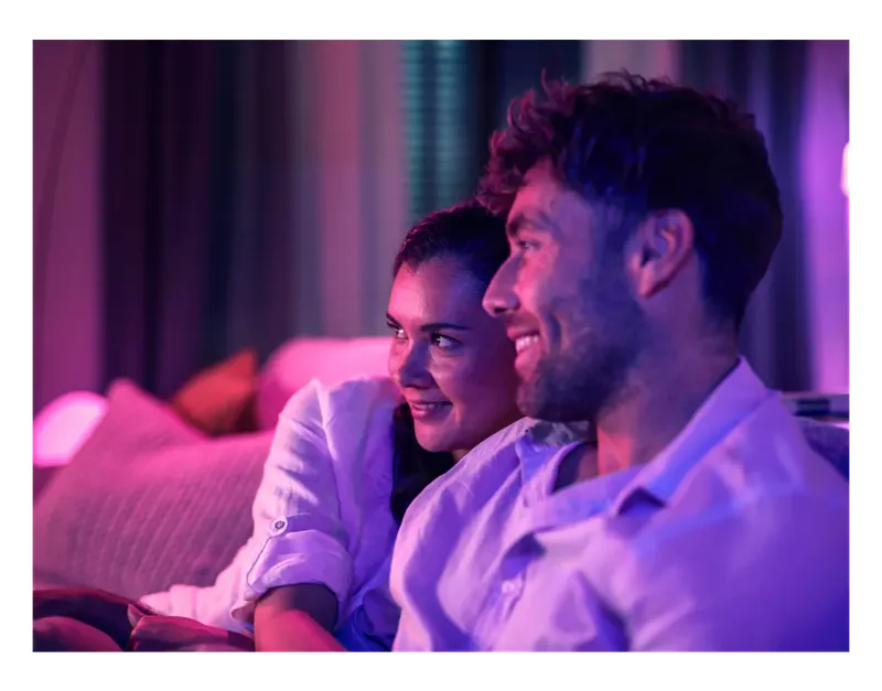 Couple watching TV lit by the Philips Hue Play Gradient Lightstrip